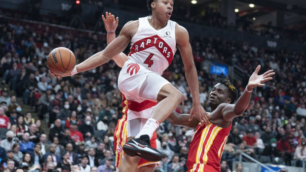 Apr 5, 2022; Toronto, Ontario, CAN; Toronto Raptors forward Scottie Barnes (4) controls the ball as Atlanta Hawks center Clint Capela (15) tries to defend during the fourth quarter at Scotiabank Arena. Mandatory Credit: Nick Turchiaro-USA TODAY Sports